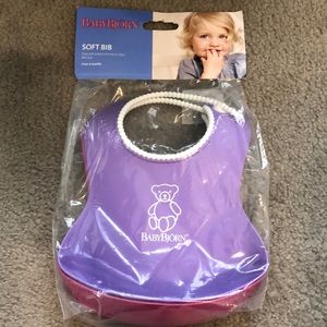 Baby Bjorn plastic bibs with spill pocket.